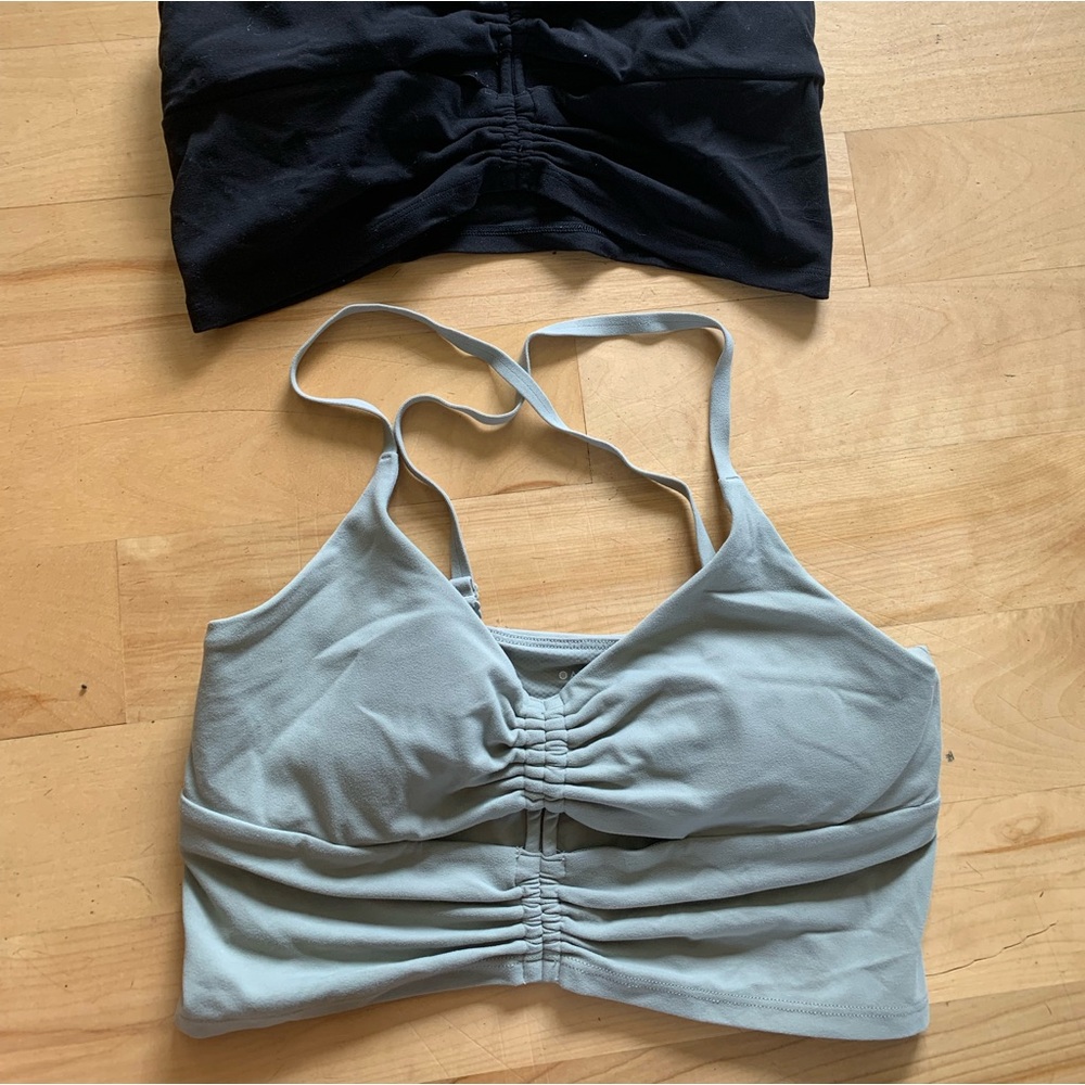 Athleta light support bra small. 1 black. 1 soft green.